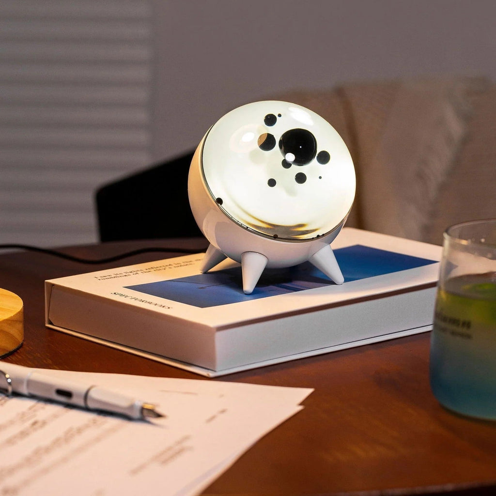 Sound-reactive ferrofluid display in clear glass sphere with black liquid pulsing to music rhythm 5