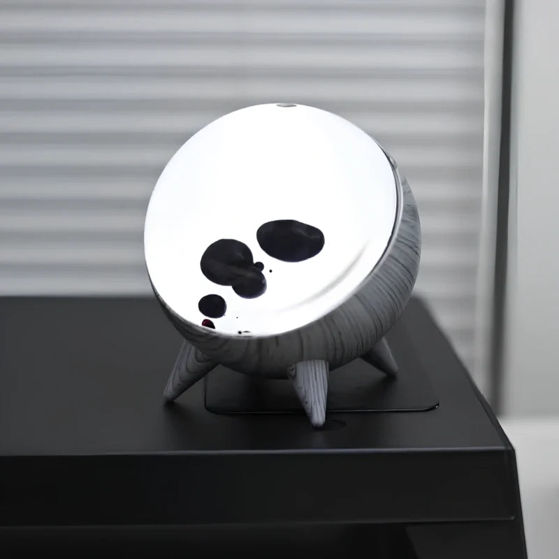 Sound-reactive ferrofluid display in clear glass sphere with black liquid pulsing to music rhythm 9